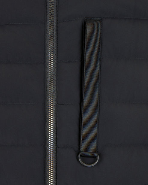 Close-up of a black jacket with a zipper and a black fabric loop with a silver ring.