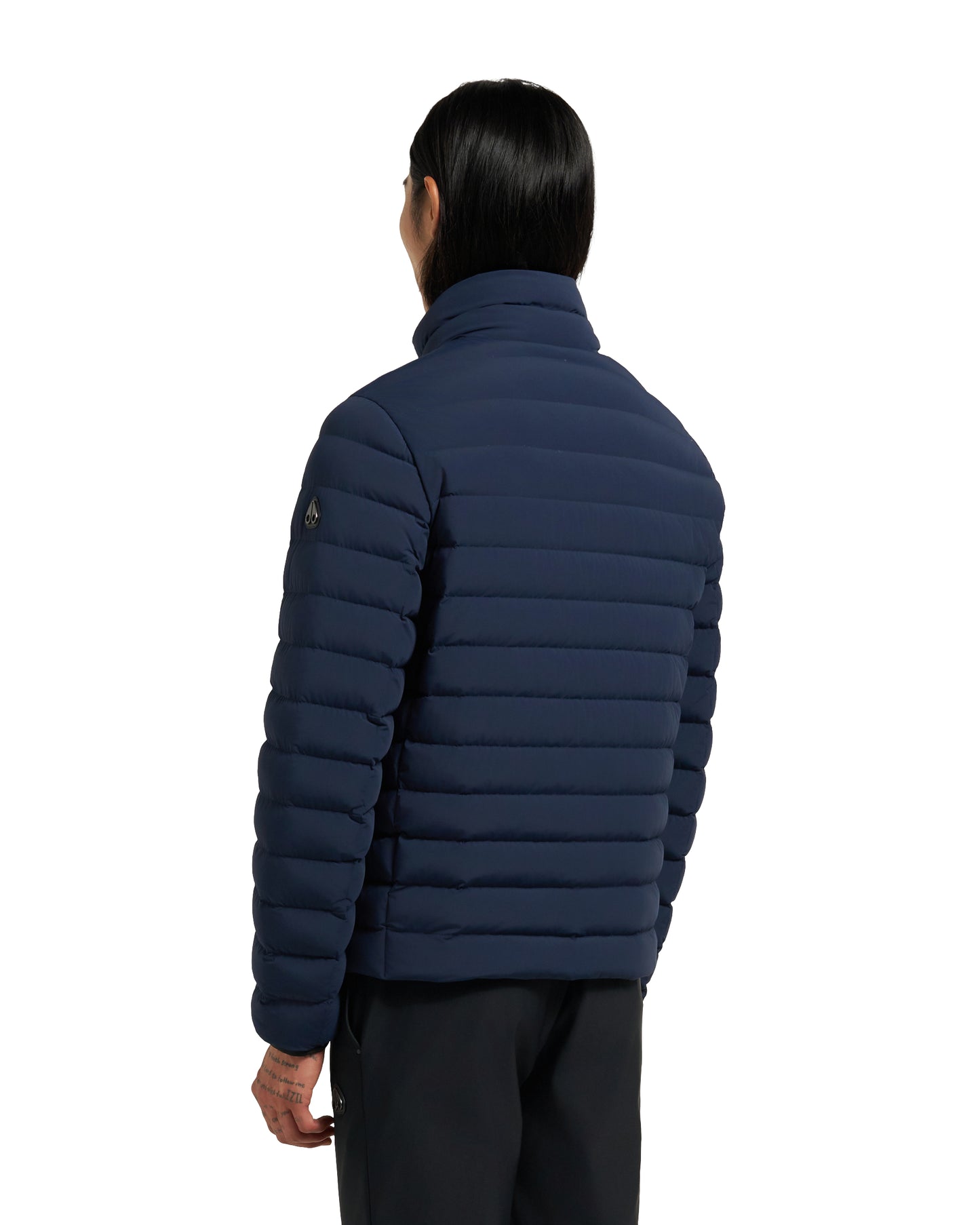 Navy blue puffer jacket worn by a person facing away from the viewer.