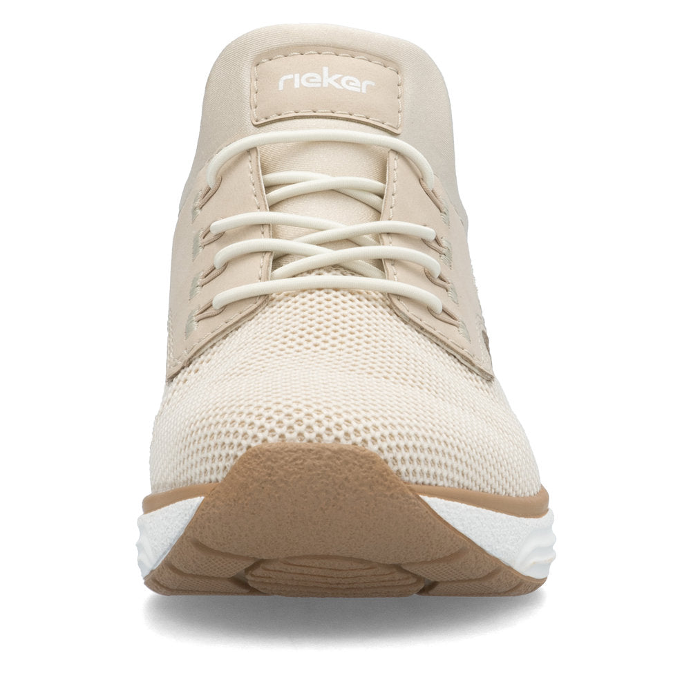 Cream-colored athletic shoe with a light tan sole and white laces. The word "Rieker" is displayed on the top of the shoe.