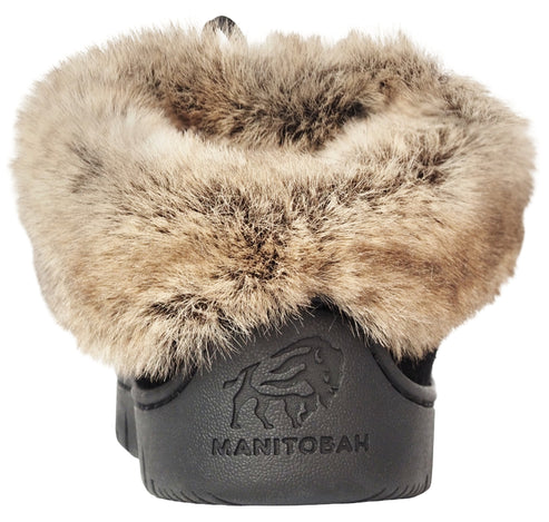 Rear view of a black winter boot featuring a thick, fluffy, brown-and-tan faux fur collar and a debossed buffalo logo above the embossed text MANITOBAH on the heel.