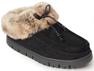 A black suede slip-on shoe with a thick tan faux-fur collar, featuring a decorative black drawstring tie with knotted details on the front and a thick, ridged black rubber sole.