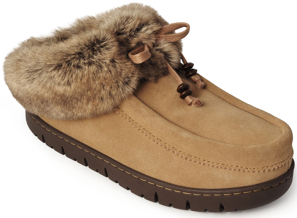 A tan suede slip-on shoe with a thick brown textured sole and a plush brown faux fur collar, featuring decorative laces with small wooden beads at the center.