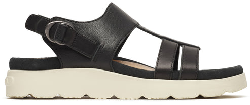 Black sandal with a thick, beige sole and buckle.