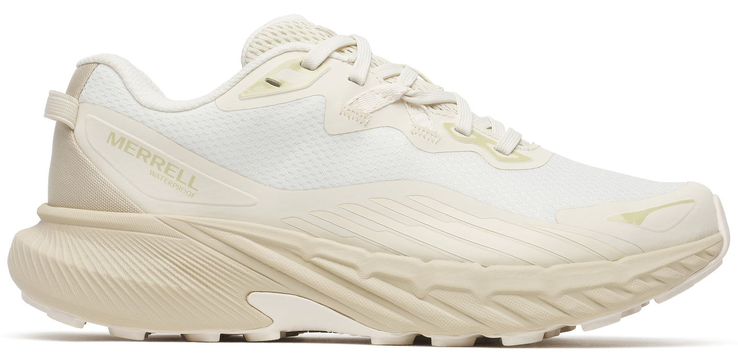 Off-white running shoe with thick ridged sole, and 'MERRELL' written near the heel.