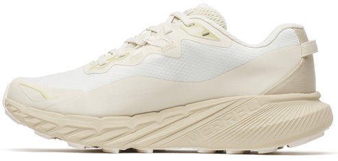 Beige running shoe with patterned sole.