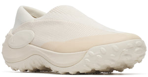Slip-on off-white shoe with knit upper, rounded toe, thick midsole and spiky outsole.