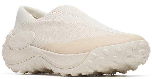 Slip-on off-white shoe with knit upper, rounded toe, thick midsole and spiky outsole.