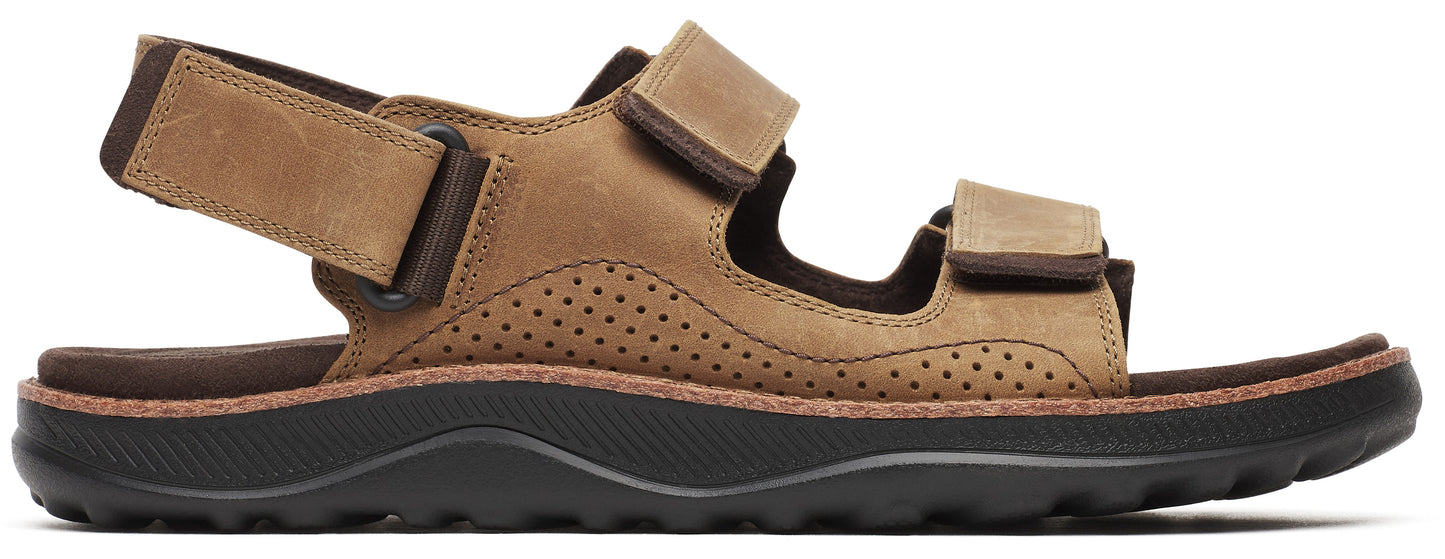 A brown sandal with a thick black sole.