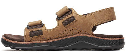 a tan sandal with velcro straps and a black sole