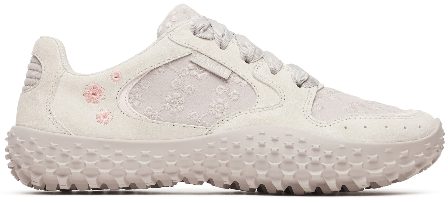 Off-white sneaker with a textured sole and pink flower details.