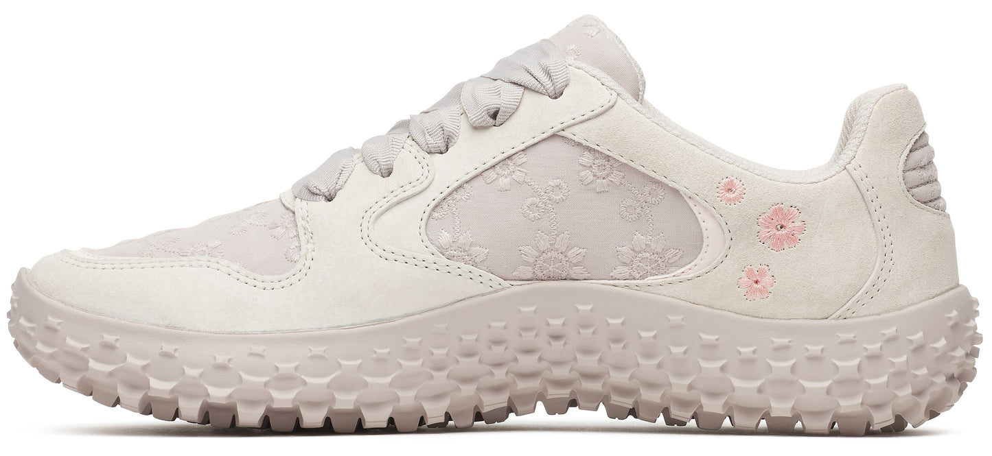 A floral designed sneaker with light pink flower details.