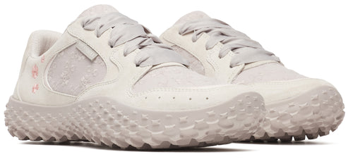 A pair of light-gray shoes with a unique studded sole and a floral pattern near the heel.