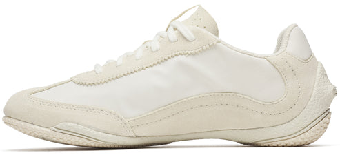 An off-white sneaker made of suede and textile with a low profile.
