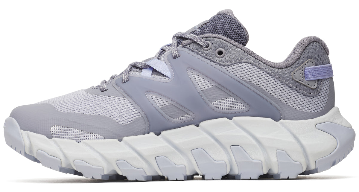 A light gray running shoe with a white zig-zag sole.