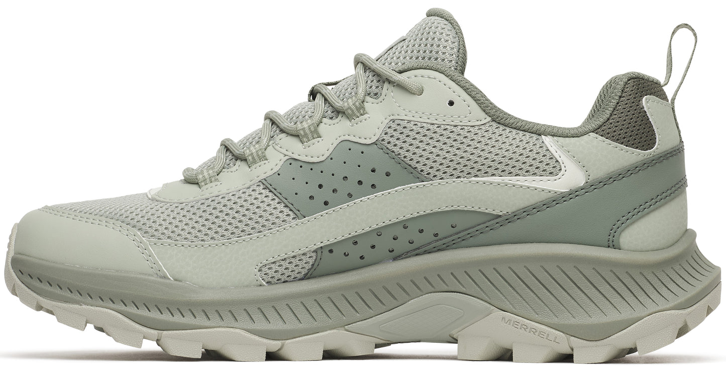 A light sage green athletic hiking sneaker shown from a side view, featuring a mesh upper, perforated leather overlays, a thick ribbed midsole, and a rugged trail-ready outsole, with Merrell logo visible on the heel sole.