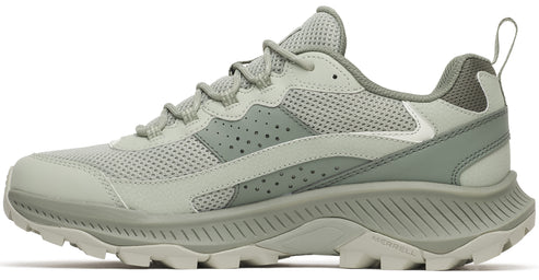 A light sage green athletic hiking sneaker shown from a side view, featuring a mesh upper, perforated leather overlays, a thick ribbed midsole, and a rugged trail-ready outsole, with Merrell logo visible on the heel sole.