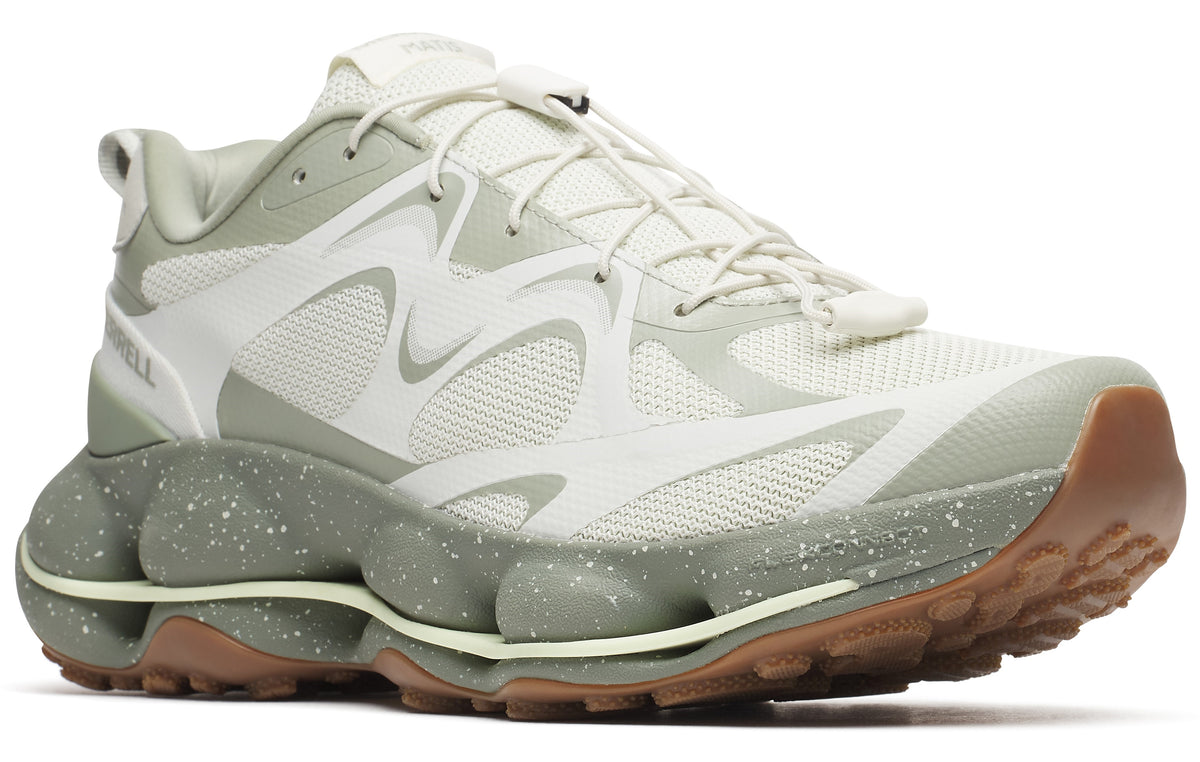 Low-profile trail running shoe in white and sage green featuring a lace-up closure and a thick sole with green bubble-like accents.