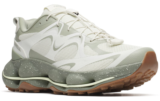 Low-profile trail running shoe in white and sage green featuring a lace-up closure and a thick sole with green bubble-like accents.
