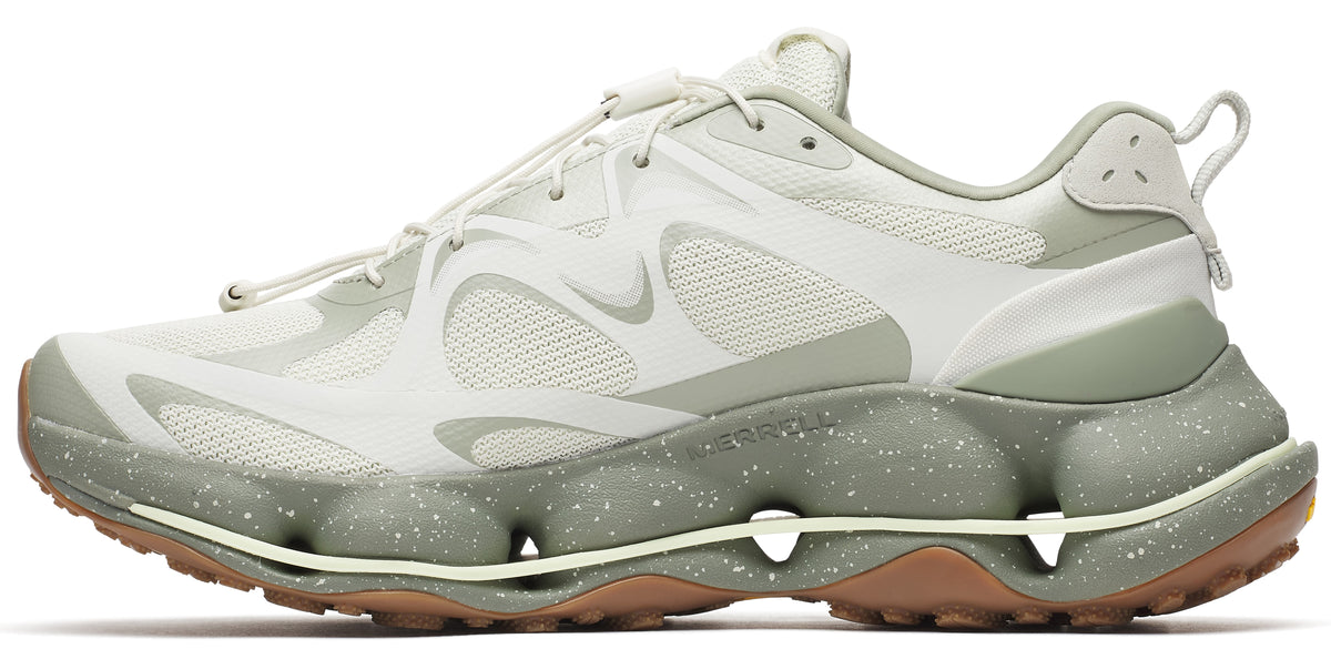 A sneaker featuring a neutral color scheme, with a mesh upper, an intricate lacing system, and a speckled sole.