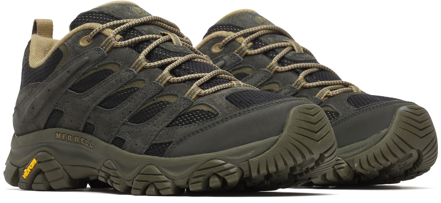 A pair of dark green hiking shoes with tan laces and Vibram soles.