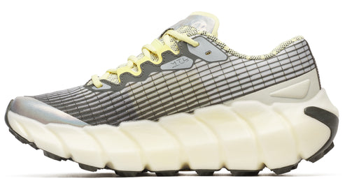 Gray running shoe with exaggerated white textured sole and yellow laces.