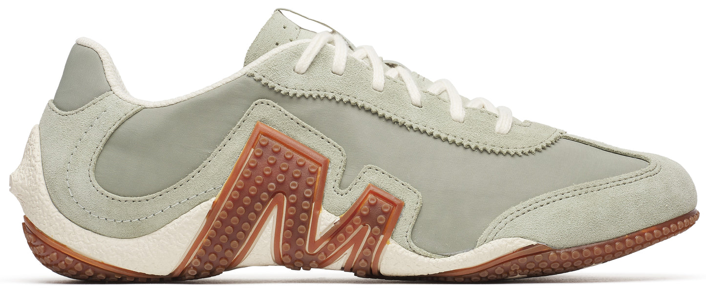 A low-top sneaker featuring an 'M' design on its side.