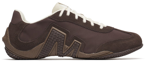 A brown sneaker with a white sole and laces.