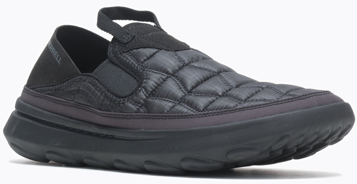 A black slip-on shoe with a quilted top and thick, contoured sole, featuring a fabric pull tab at the top.