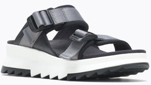 Sandals with black straps and gray webbing details, a white platform sole and black zig-zag tread.
