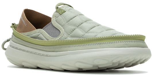 Slip-on shoe with a quilted, light green upper, light green trim, neutral toned fabric and leather back, and thick white sole.