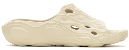 A beige, molded clog-style shoe with an organic, wavy pattern and several holes.