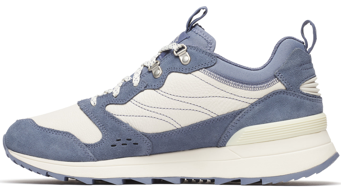 Side view of a blue and white sneaker with metal eyelets and a lugged sole.