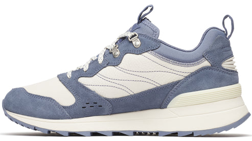 Side view of a blue and white sneaker with metal eyelets and a lugged sole.