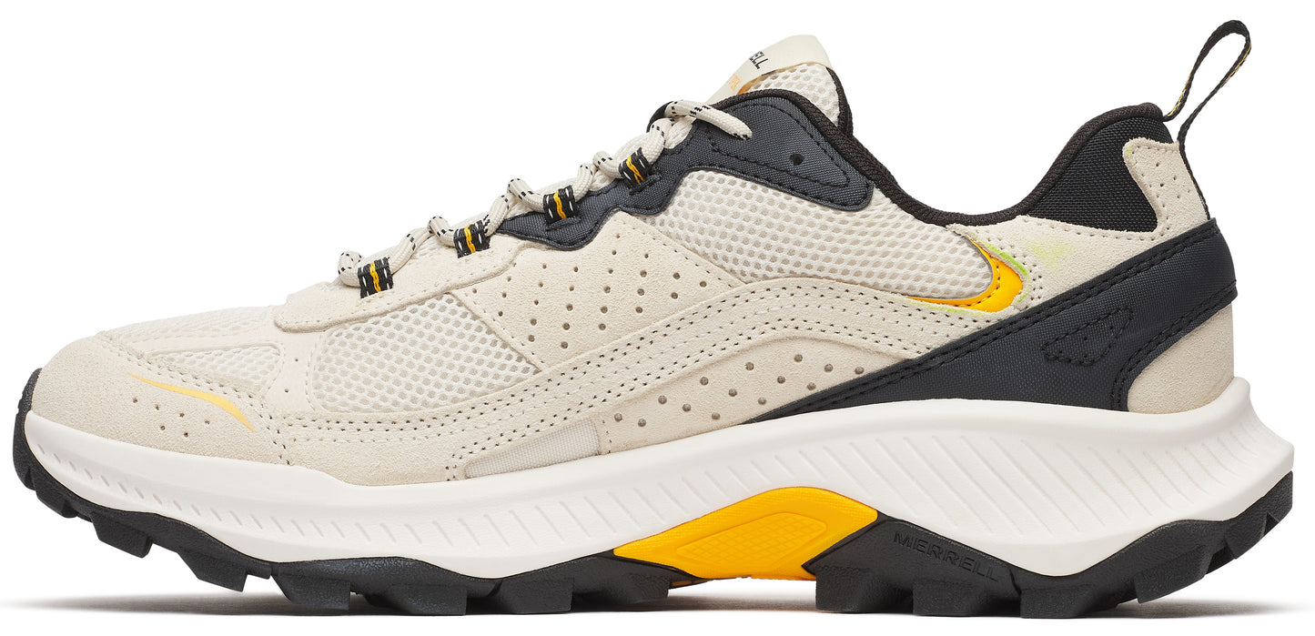beige shoe with a black and yellow accent