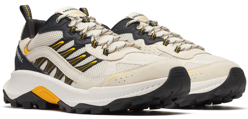 Pair of hiking shoes featuring cream uppers with black and yellow accents and a rugged sole.
