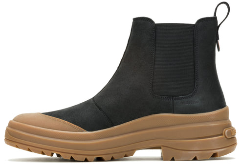 A black Chelsea style boot with tan sole and heel.