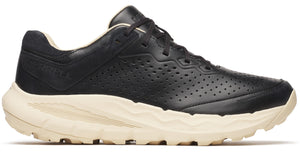 Black athletic shoe with perforated leather upper and off-white textured sole.