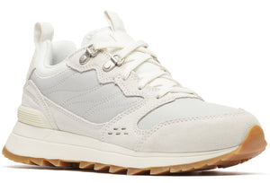 Off-white sneaker with lug sole, suede details, and metal eyelets.