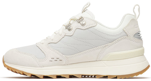 A low-profile white sneaker with metal eyelets and a lugged brown sole.