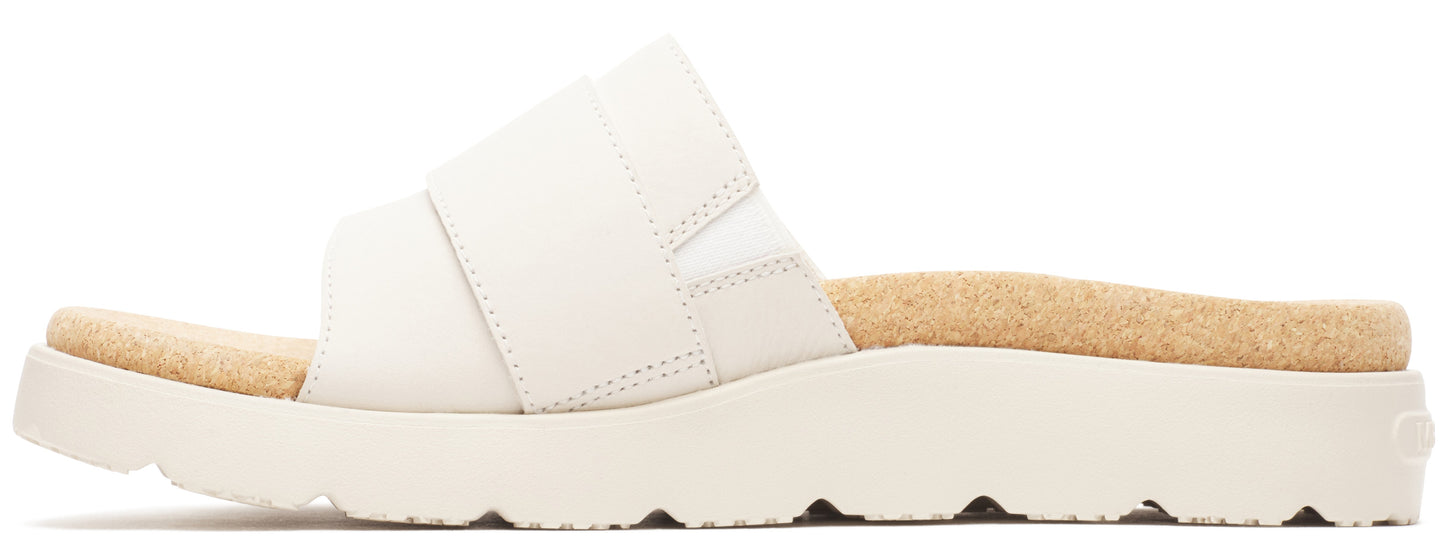 A white sandal with a thick sole and a tan footbed.