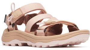 Peach-colored sandal with multiple adjustable velcro straps and a thick, light-tan sole with a rugged tread.