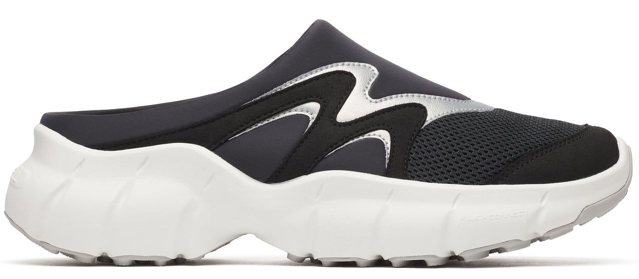 A black slip-on shoe with silver accents and a thick white sole.