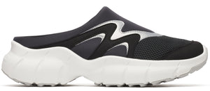 A black slip-on shoe with silver accents and a thick white sole.