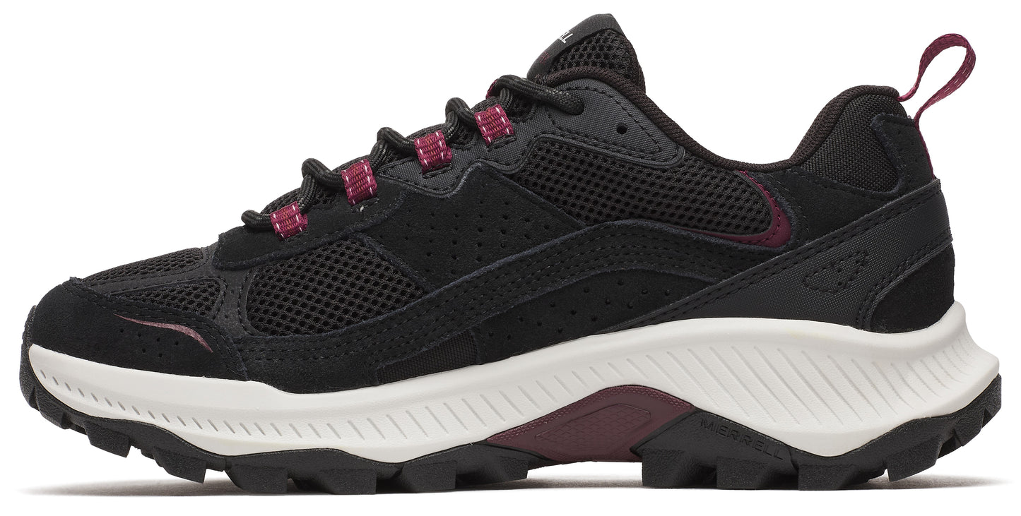 A side-view of a black walking shoe with a white midsole and a dark-colored outsole.