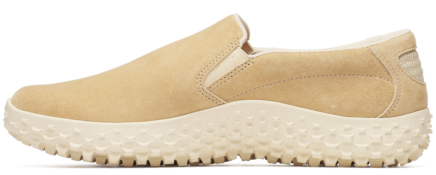Beige slip-on sneaker with a chunky, textured sole.