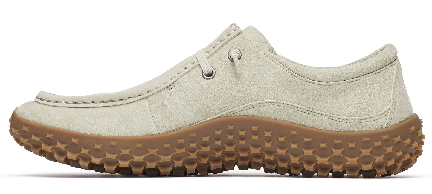A beige casual shoe with a thick, brown, rubber sole with bubble treads.