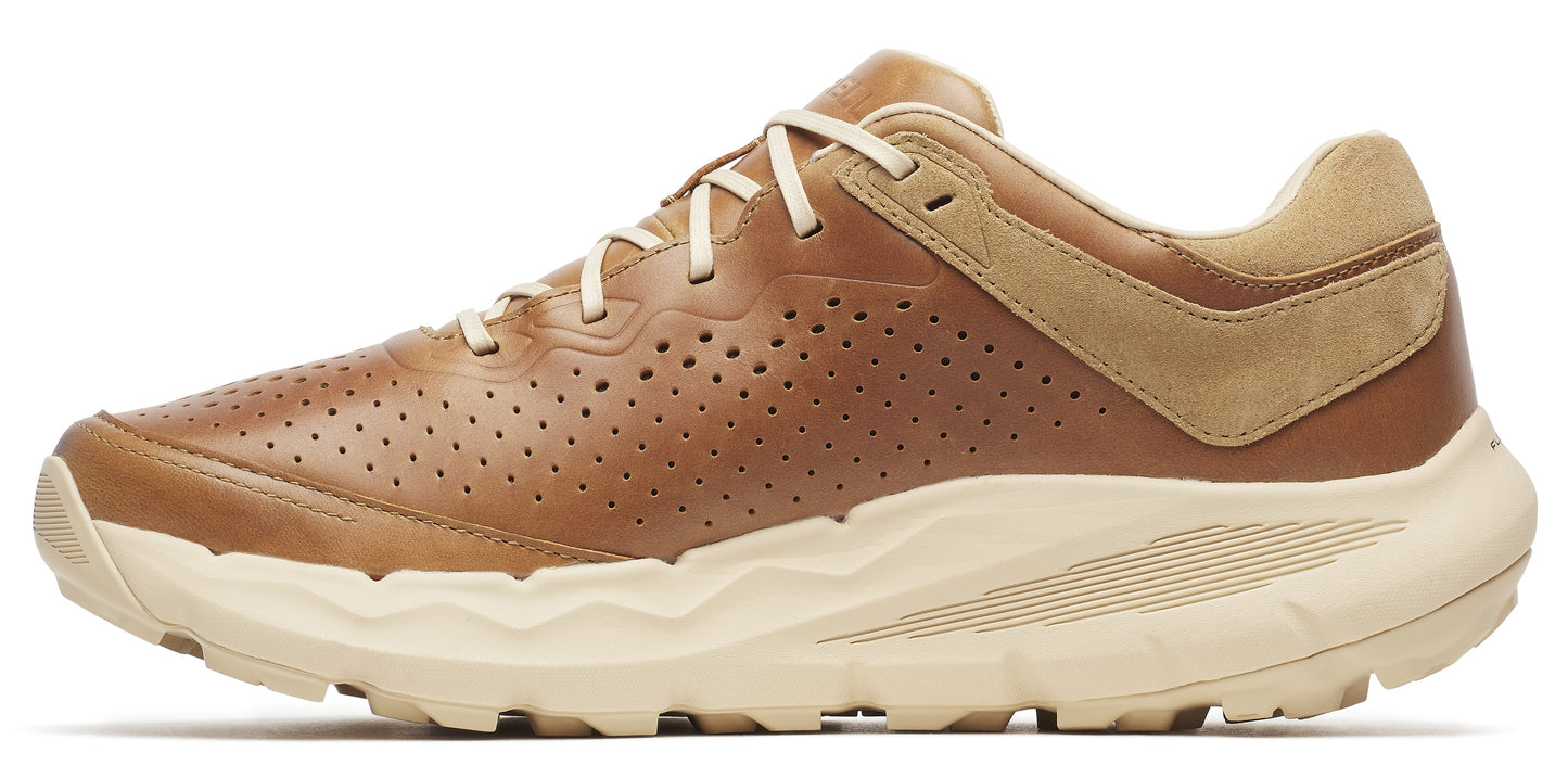 A tan-colored shoe with round ventilation holes on the side.