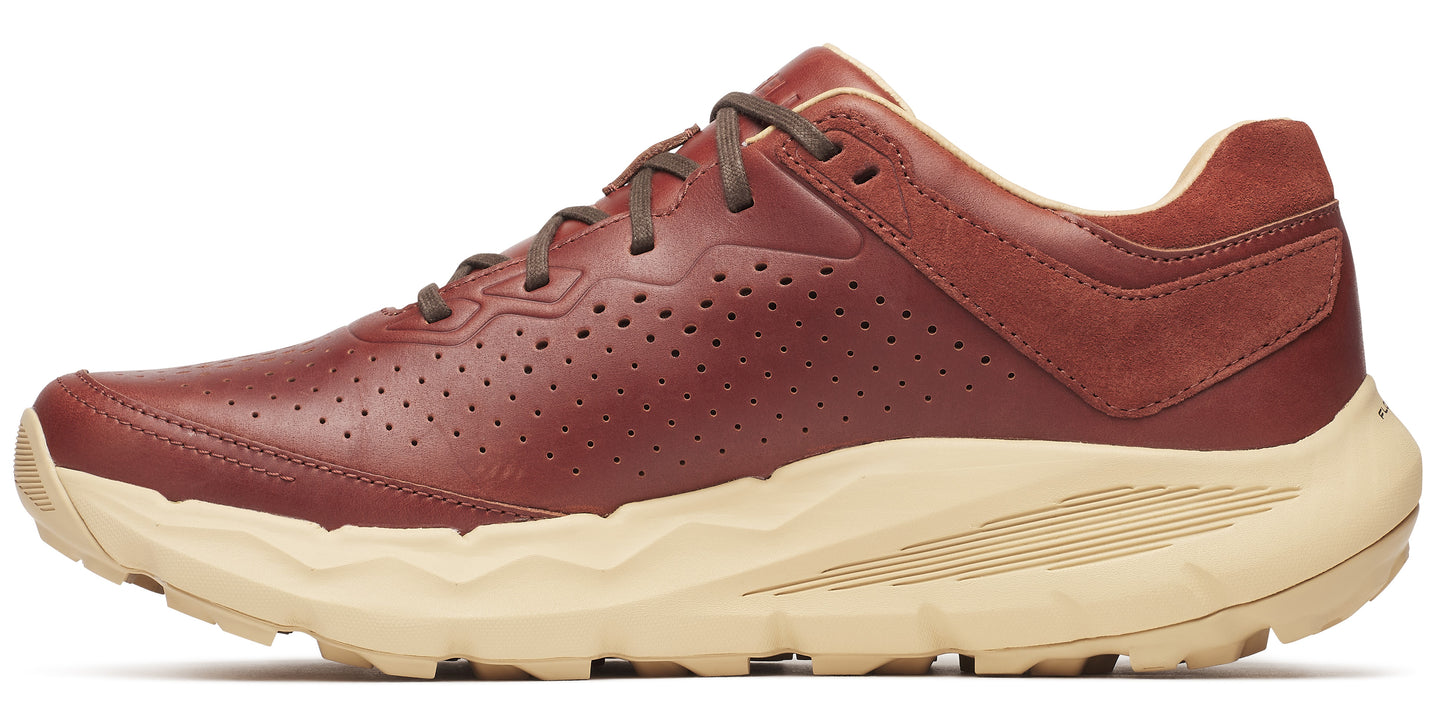 A brown leather shoe with brown laces on a tan sole.