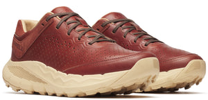 A pair of red leather sneakers with brown laces and tan soles.