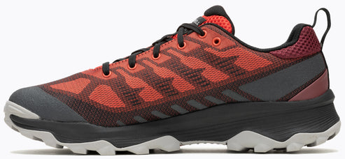 A red and black running shoe with a lace-up closure and a rugged sole.